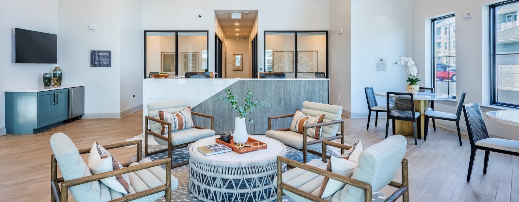 a leasing office with a front desk and chairs