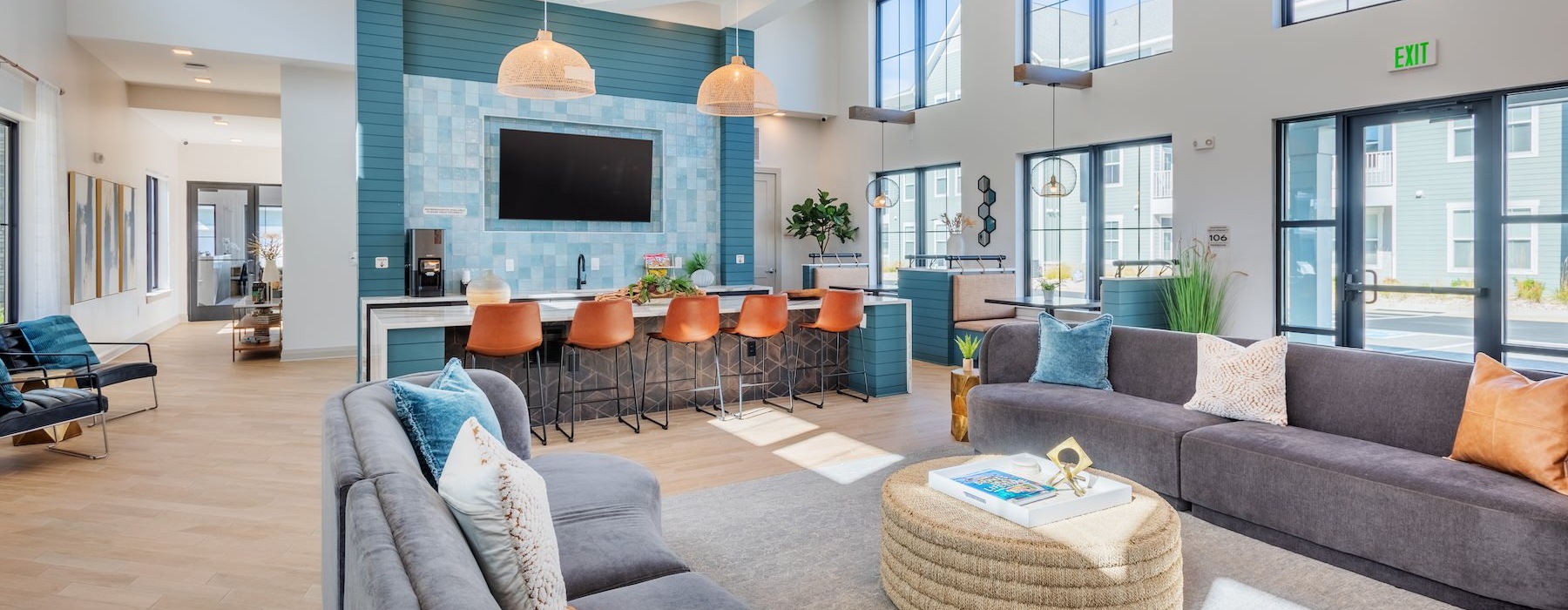 a clubroom with a tv, couches and chairs